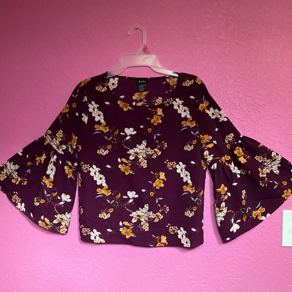 I’m selling size small purple blouse with orange, white, and blue flowers on it.